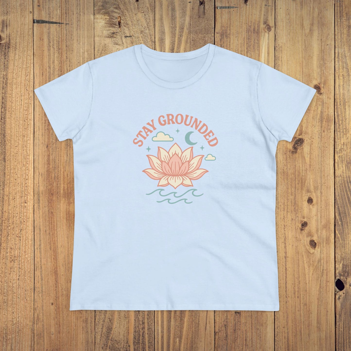 Front view of the Stay Grounded Spiritual Tee in light blue color, displaying a serene lotus graphic suited for summer events and casual wear.