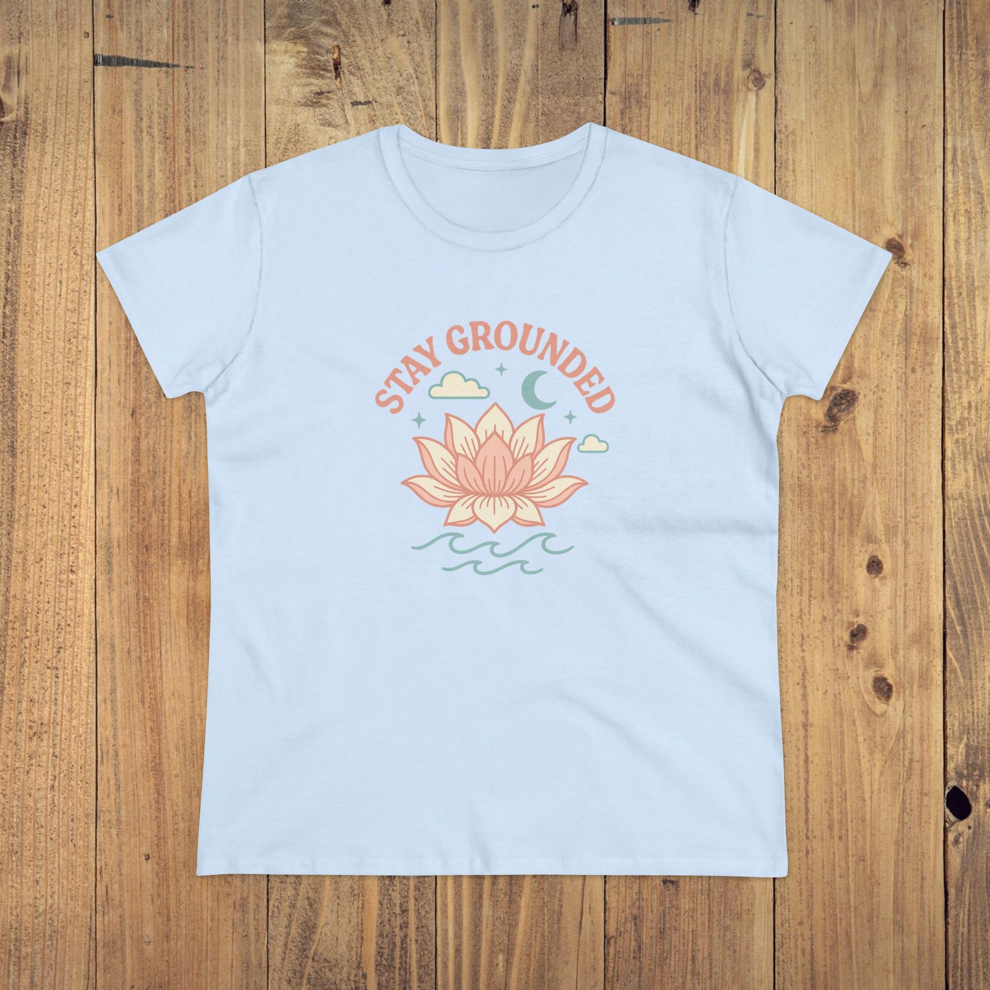 Front view of the Stay Grounded Spiritual Tee in light blue color, displaying a serene lotus graphic suited for summer events and casual wear.