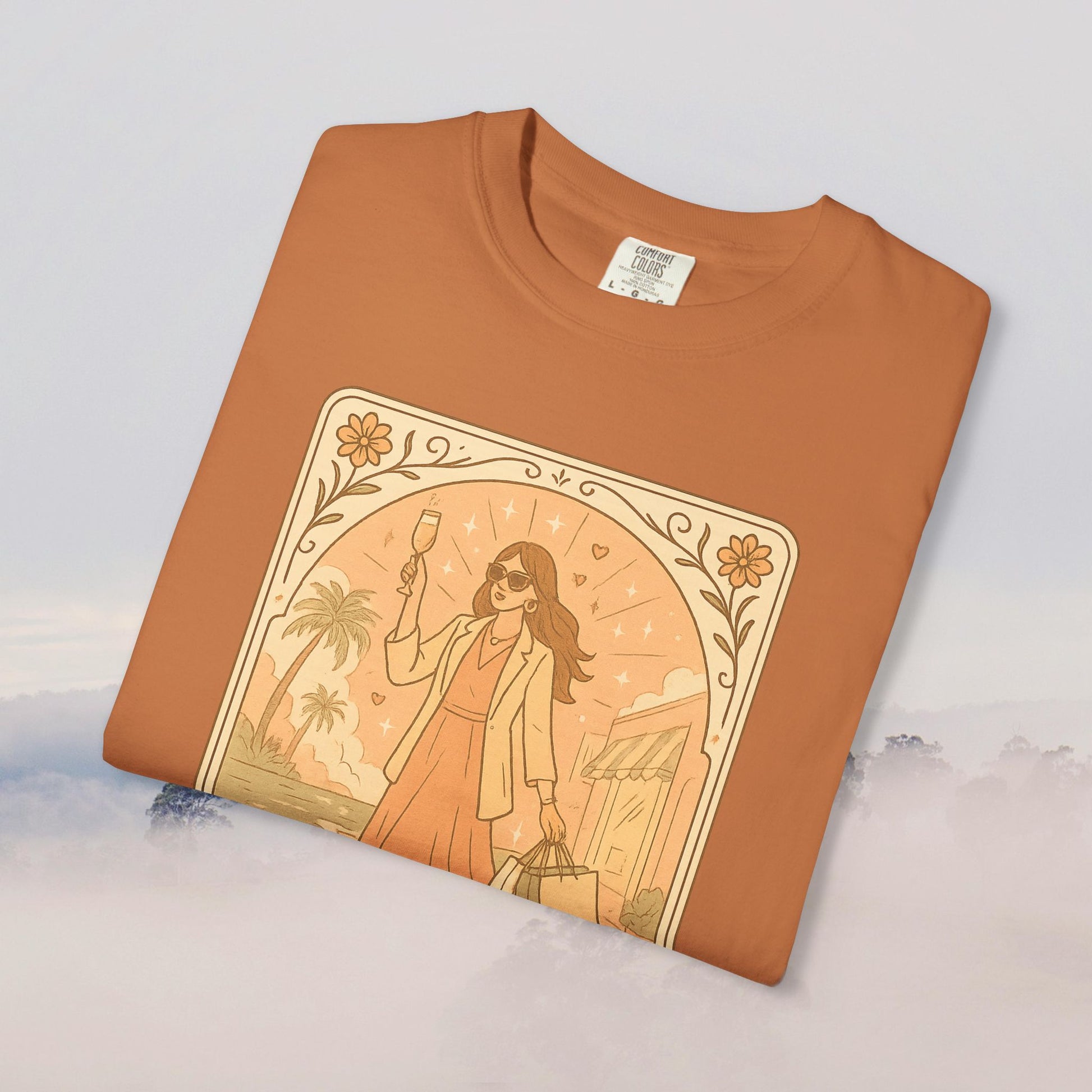 Brunch Babe Tarot Graphic Tee in earthy orange, showcasing a fashionable woman with a drink, ideal for relaxed style, crafted from 100% cotton.