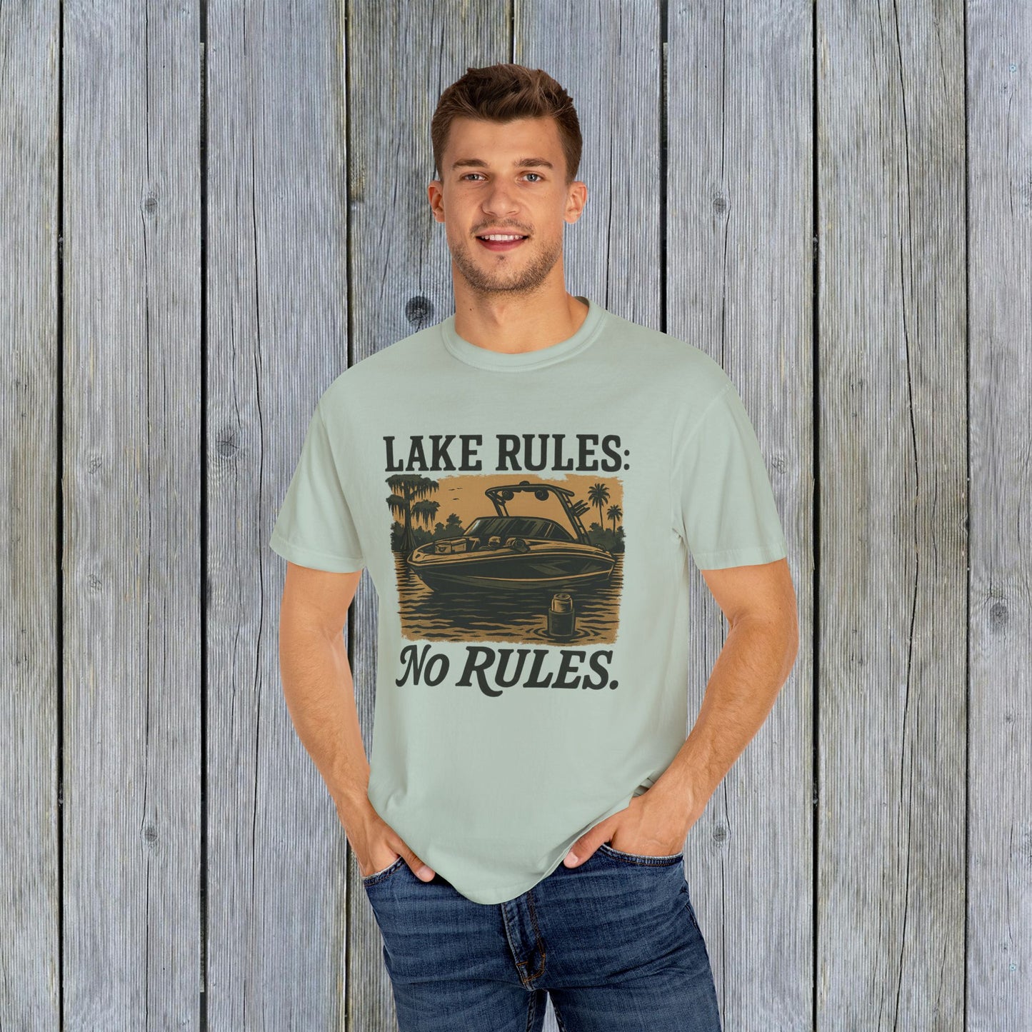 Man wearing Unisex Garment-Dyed Lake Rules Tee, standing confidently in a casual setting with a lake-inspired design, perfect for adventure seekers.