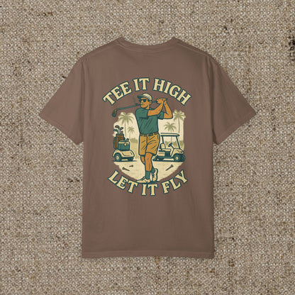 Tee It High Let It Fly Graphic Tee in brown, showcasing a golfer in action with golf carts and palm trees behind. Perfect for stylish golf lovers.