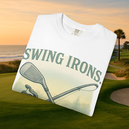 Swing Irons Cast Lines T-Shirt displayed on a golf course background, featuring a stylish design with golf and fishing elements, made of soft 100% cotton for maximum comfort.