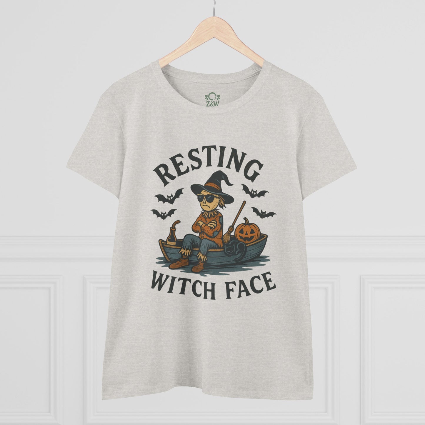 Front view of the light gray 'Resting Witch Face Halloween T-Shirt for Women, Unisex Funny Cotton Tee for Parties and Gifts' with a whimsical witch graphic, set against a stylish background.