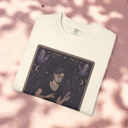 Intuitive Tarot Tee in classic white, shown against a light pink surface, depicting a woman with a crystal, made from 100% high-quality cotton for comfort.