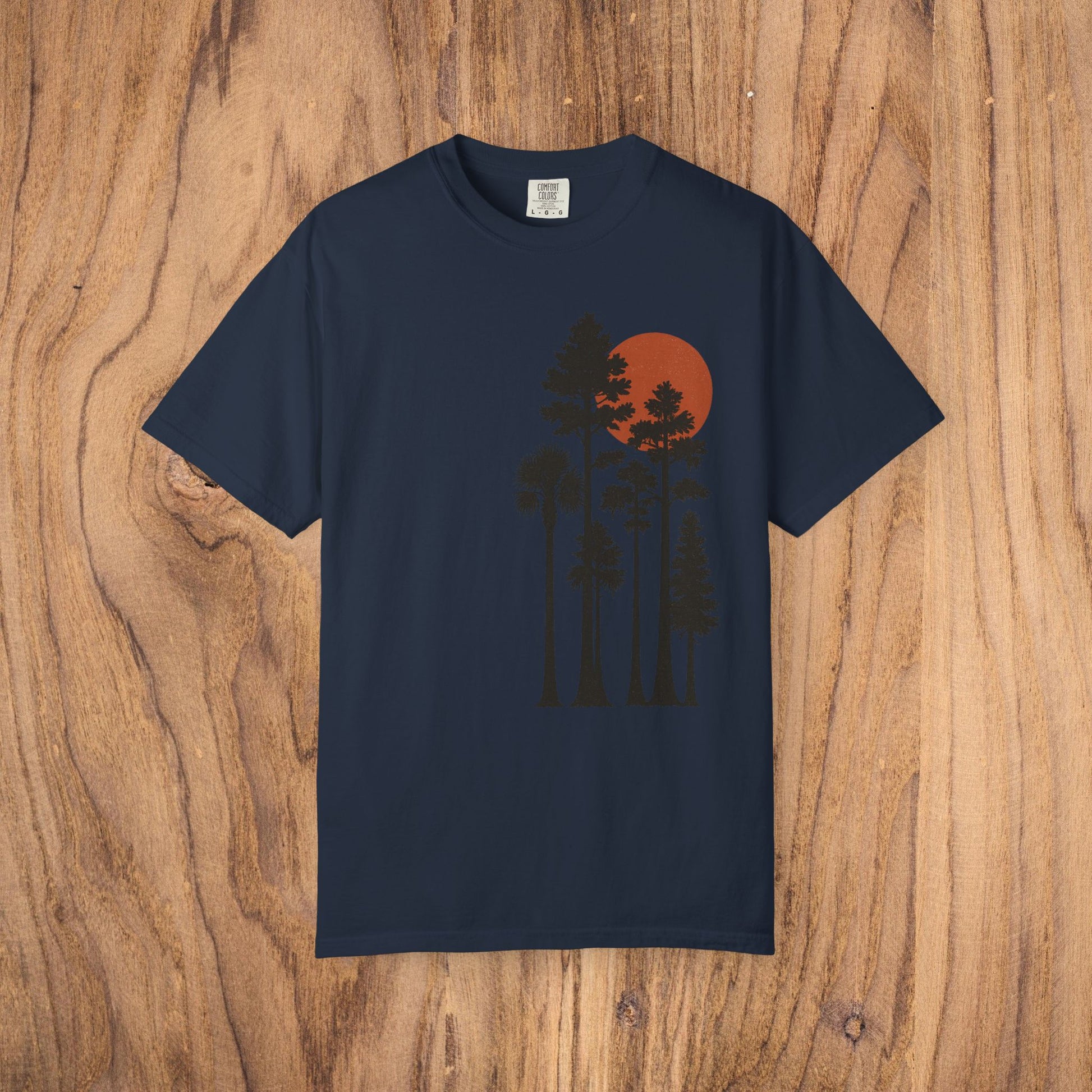 Sunset Trees Unisex T-Shirt in navy blue, featuring a serene graphic design of trees against a red sunset, made from soft 100% cotton, perfect for casual and semi-formal wear.