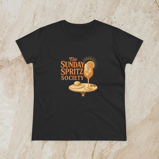 Black Women's Midweight Cotton Tee displaying 'The Sunday Spritz Society' graphic with an artistic cocktail design, ideal for a stylish and comfortable everyday look.