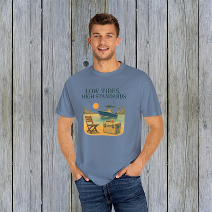 Model wearing the Garment-Dyed Low Tides High Standards T-Shirt in blue, featuring a vibrant beach-themed graphic that captures a relaxed vibe.