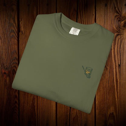 Men's Golf & Whiskey Tee featuring a stylish green design with a whiskey glass graphic, made from soft cotton and supporting eco-friendly practices.