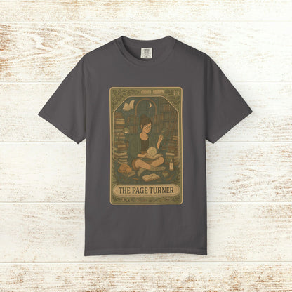 Page Turner Tarot Tee - Soft Cotton T-Shirt featured in dark gray, showcasing a whimsical design with a character surrounded by books, perfect for book lovers and tarot enthusiasts.