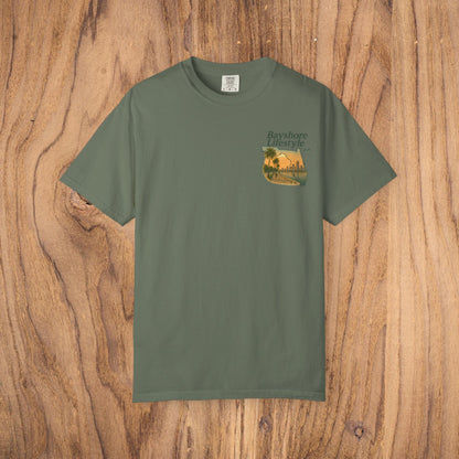 Bayshore Lifestyle Tee in forest green color, highlighting a chic palm tree illustration on a lightweight cotton material, ideal for everyday use.