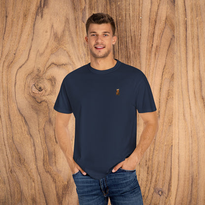 Man wearing a Premium Southern Made T-Shirt in navy, casually posing with a friendly smile against a wooden background.