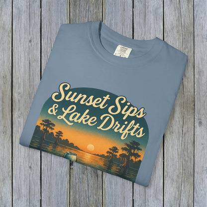 Lake Drifts T-Shirt with sunset graphic in soft blue color, highlighting the unique and durable 100% US cotton.