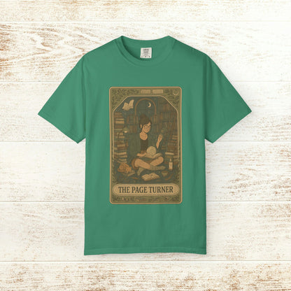 Page Turner Tarot Tee - Soft Cotton T-Shirt available in vibrant green, displaying an enchanting illustration of a character amidst books, ideal for reading aficionados.