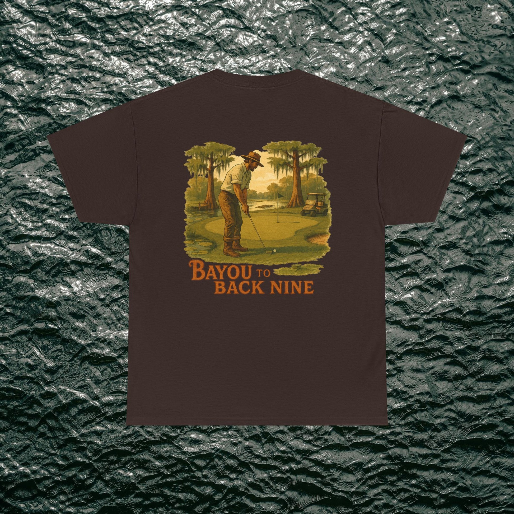 Bayou To Back Nine Softstyle Golf Tee on a dark brown t-shirt, depicting a golfer in action, designed for comfort and relaxed outings.