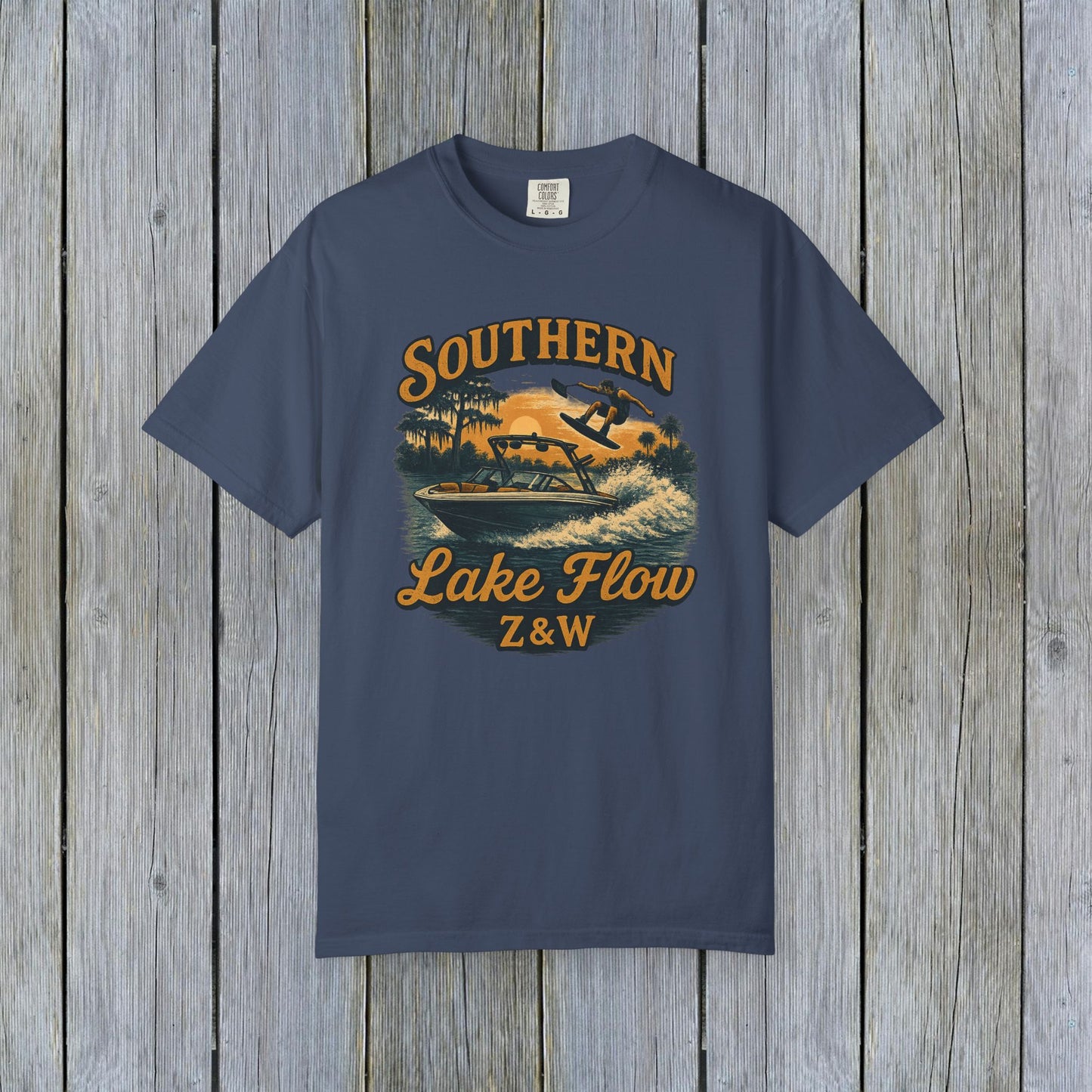 Southern Lake Flow T-Shirt in navy blue, showcasing a stylish illustration of water skiing, crafted from sustainable 100% US cotton, offered in various sizes from S to 4XL.