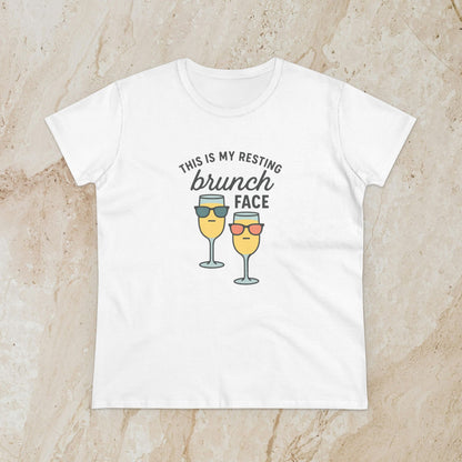 Women's Premium 100% Cotton Brunch Face Tee in white featuring a playful design with two cocktail glasses wearing sunglasses and the text 'THIS IS MY RESTING brunch FACE'. Comfortable and stylish for brunch lovers.