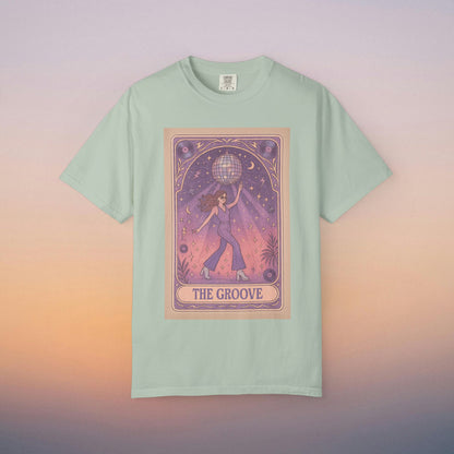 Groove Tarot Graphic Tee in mint green, featuring an enchanting illustration of a figure with a globe set in a dreamy starry scene. This 100% ring-spun cotton unisex tee is available in sizes S-4XL for a perfect fit.