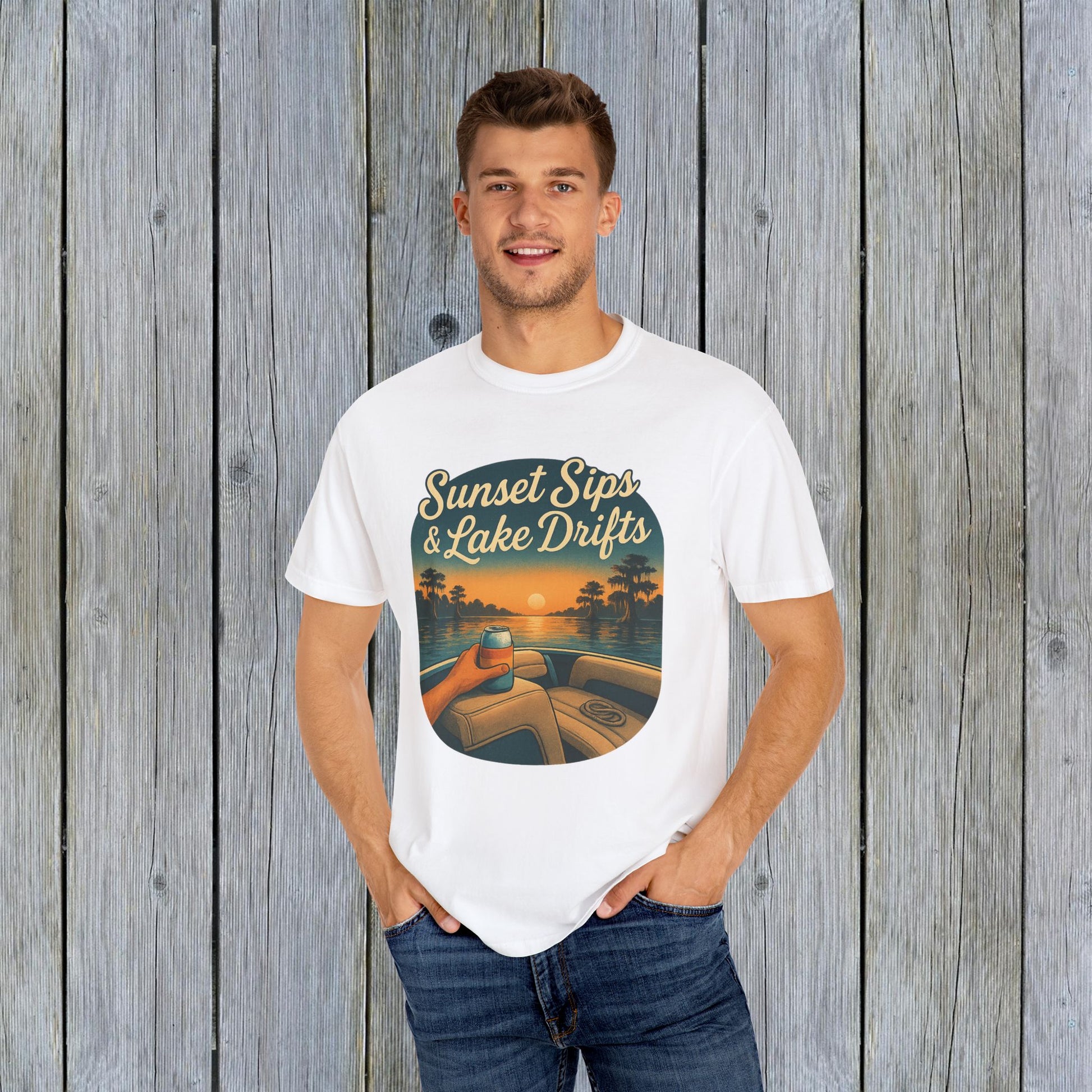 Man wearing a Lake Drifts T-Shirt in white displaying a scenic sunset over a lake, great for beach and outdoor activities.