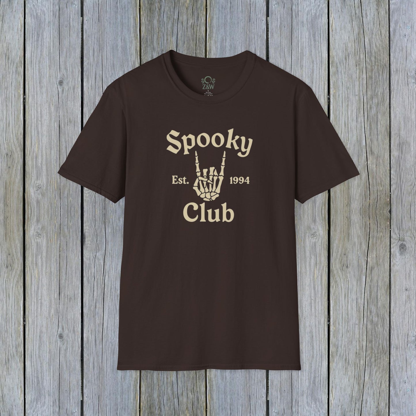 Unisex Spooky Club Tee in a dark brown color, featuring a skeleton hand graphic and text, crafted from soft 100% cotton for comfort.