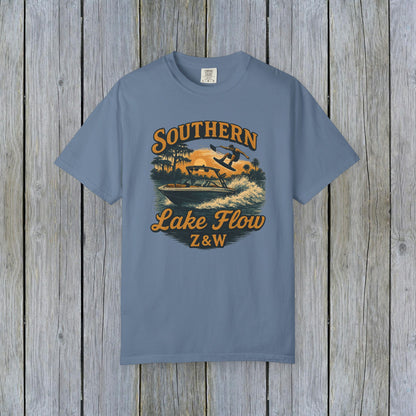Southern Lake Flow T-Shirt in slate blue, designed with a retro graphic depicting lake sport activities, made from 100% US cotton that's both durable and stylish for eco-conscious consumers.