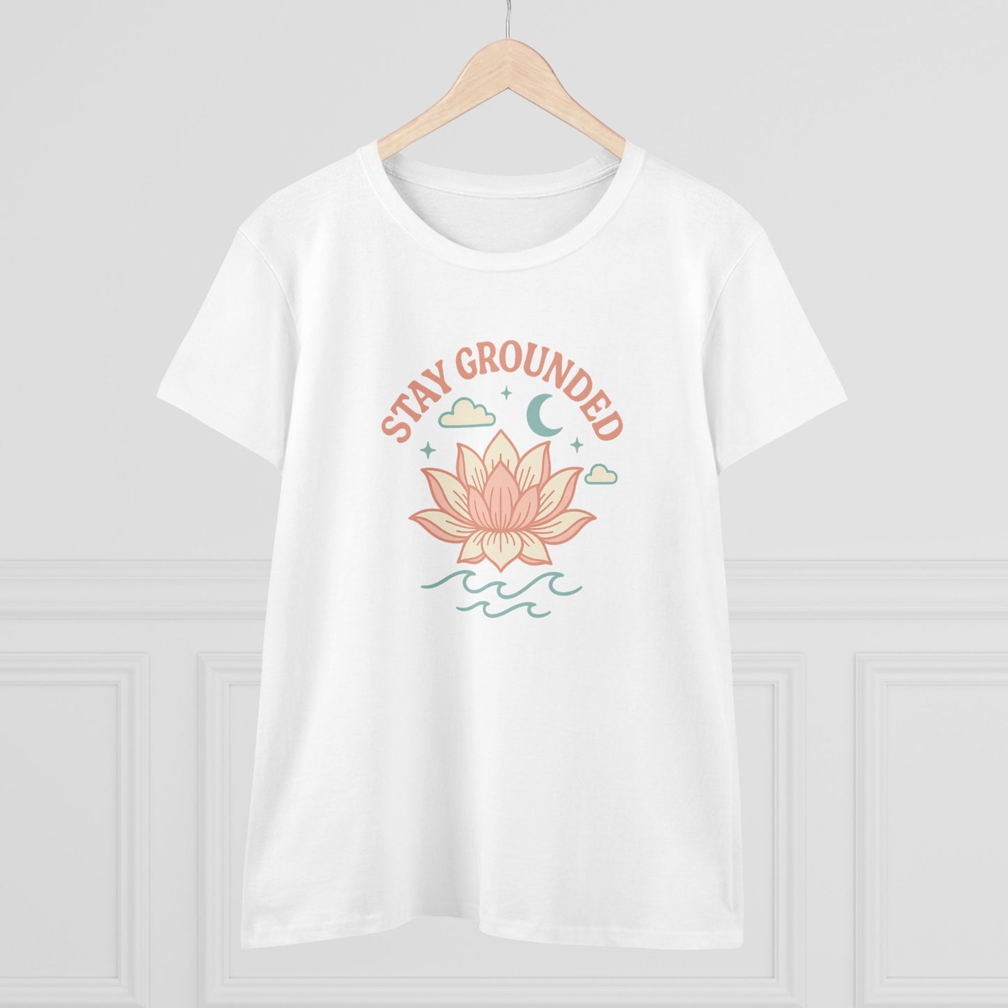 Stay Grounded Spiritual Tee displayed on a hanger, featuring a beautiful lotus illustration on a classic white crop top, ideal for warm days.