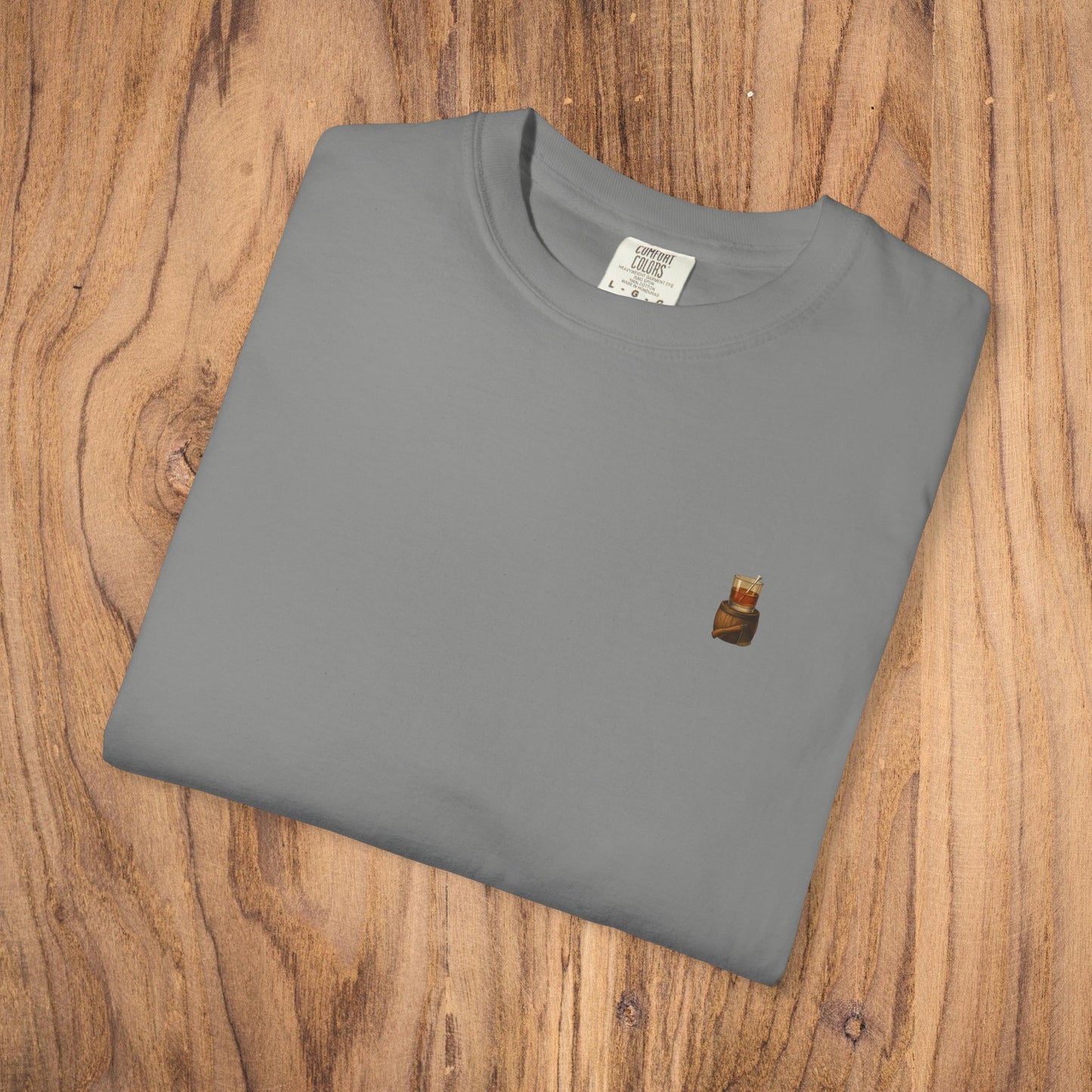 Premium Southern Made T-Shirt folded on wooden surface in grey, featuring a small logo, ideal for casual fashion. Available in multiple sizes.