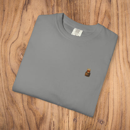 Premium Southern Made T-Shirt folded on wooden surface in grey, featuring a small logo, ideal for casual fashion. Available in multiple sizes.