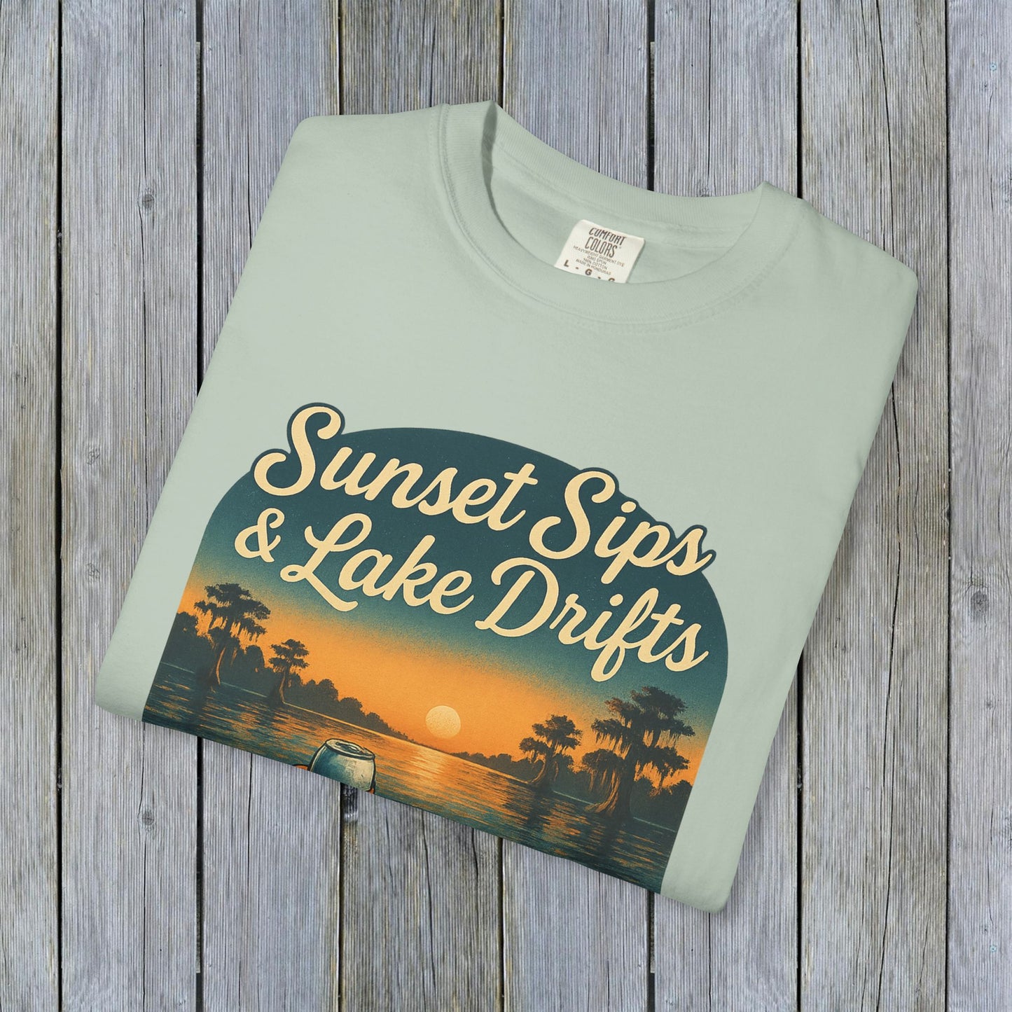 Lake Drifts T-Shirt in light green displaying the 'Sunset Sips & Lake Drifts' graphic, ideal for summer outings.