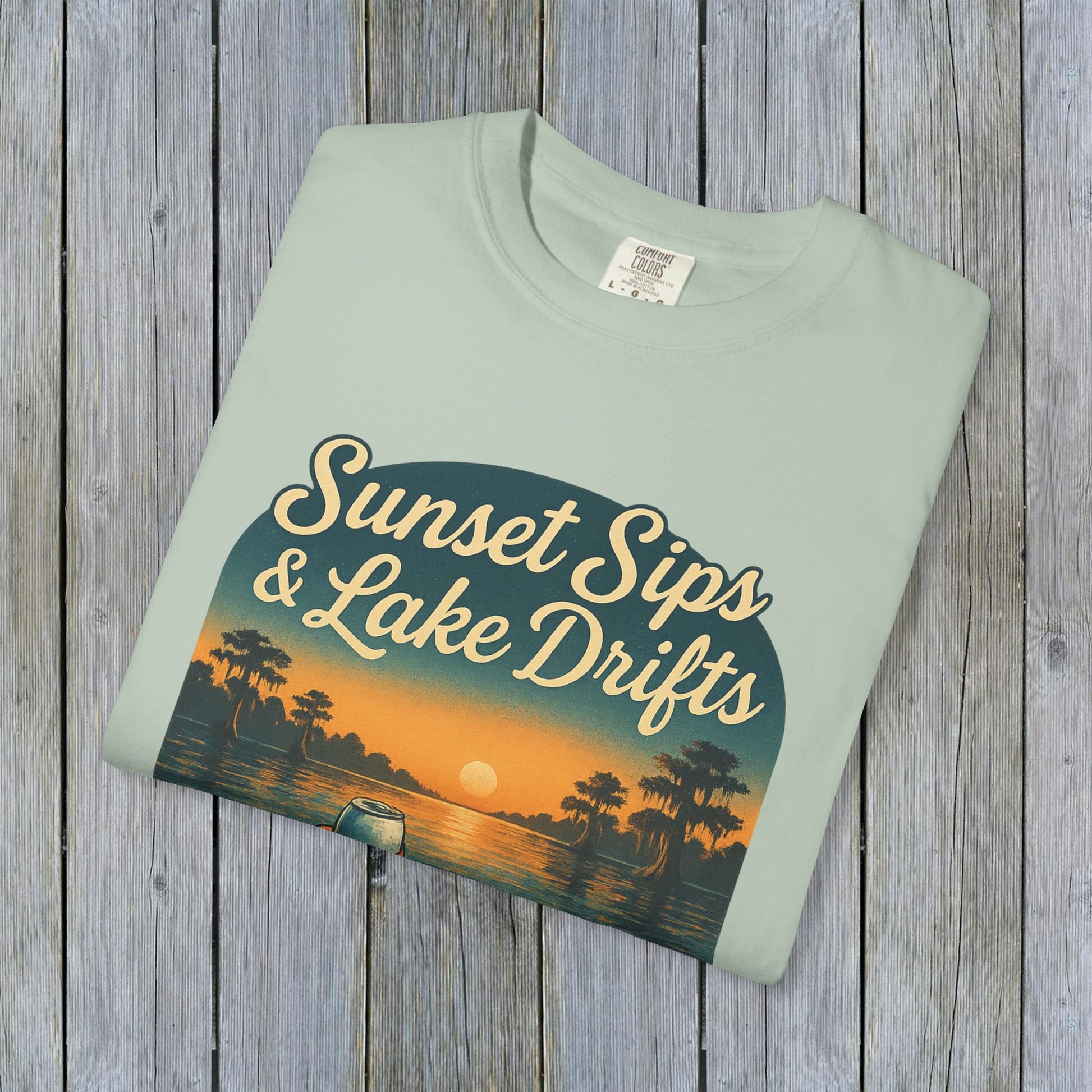 Lake Drifts T-Shirt in light green displaying the 'Sunset Sips & Lake Drifts' graphic, ideal for summer outings.