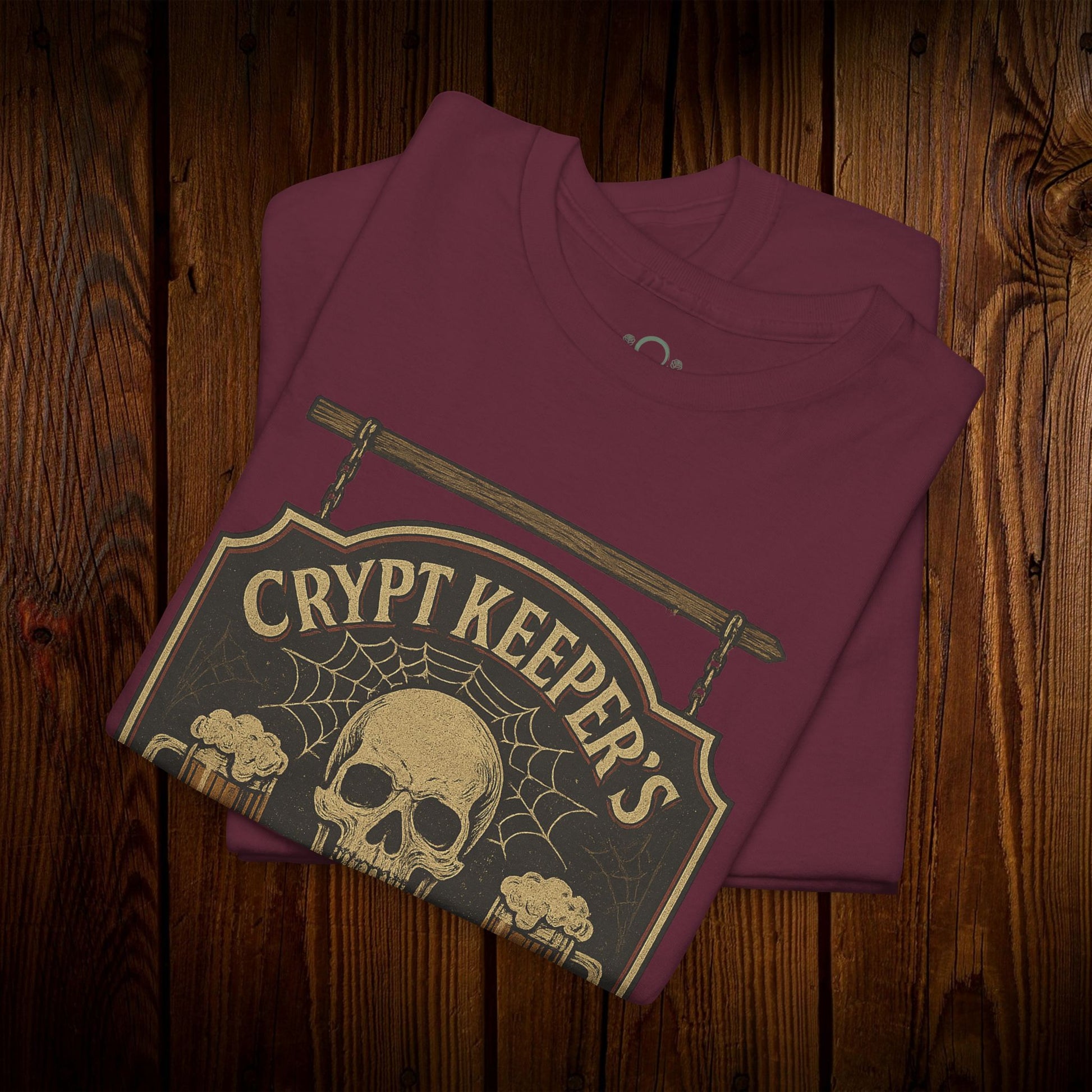 Crypt Keeper's Pub Tee in maroon color, featuring a skull and spider web design, ideal for Halloween and casual wear.
