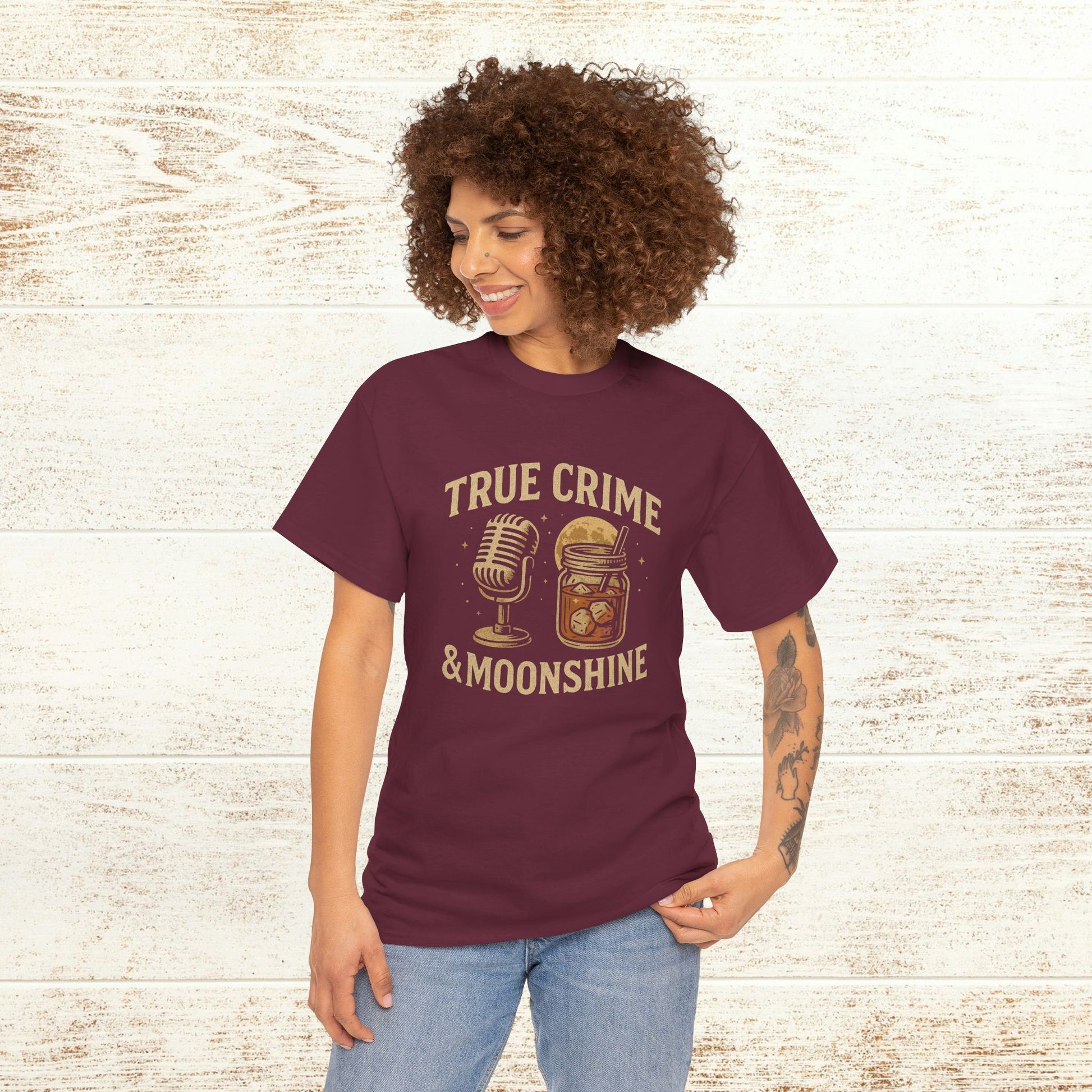 True Crime & Moonshine Unisex Graphic Tee - Vintage Casual Wear for True Crime Lovers, modeled by a person, highlighting the fun design featuring a microphone and moonshine jar in a cozy setting.