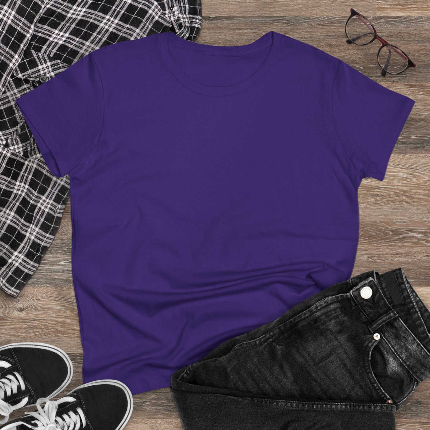 Flat lay of Unisex Dog Lover T-Shirt in purple with black jeans and a plaid shirt, showcasing a relaxed outfit for casual outings.