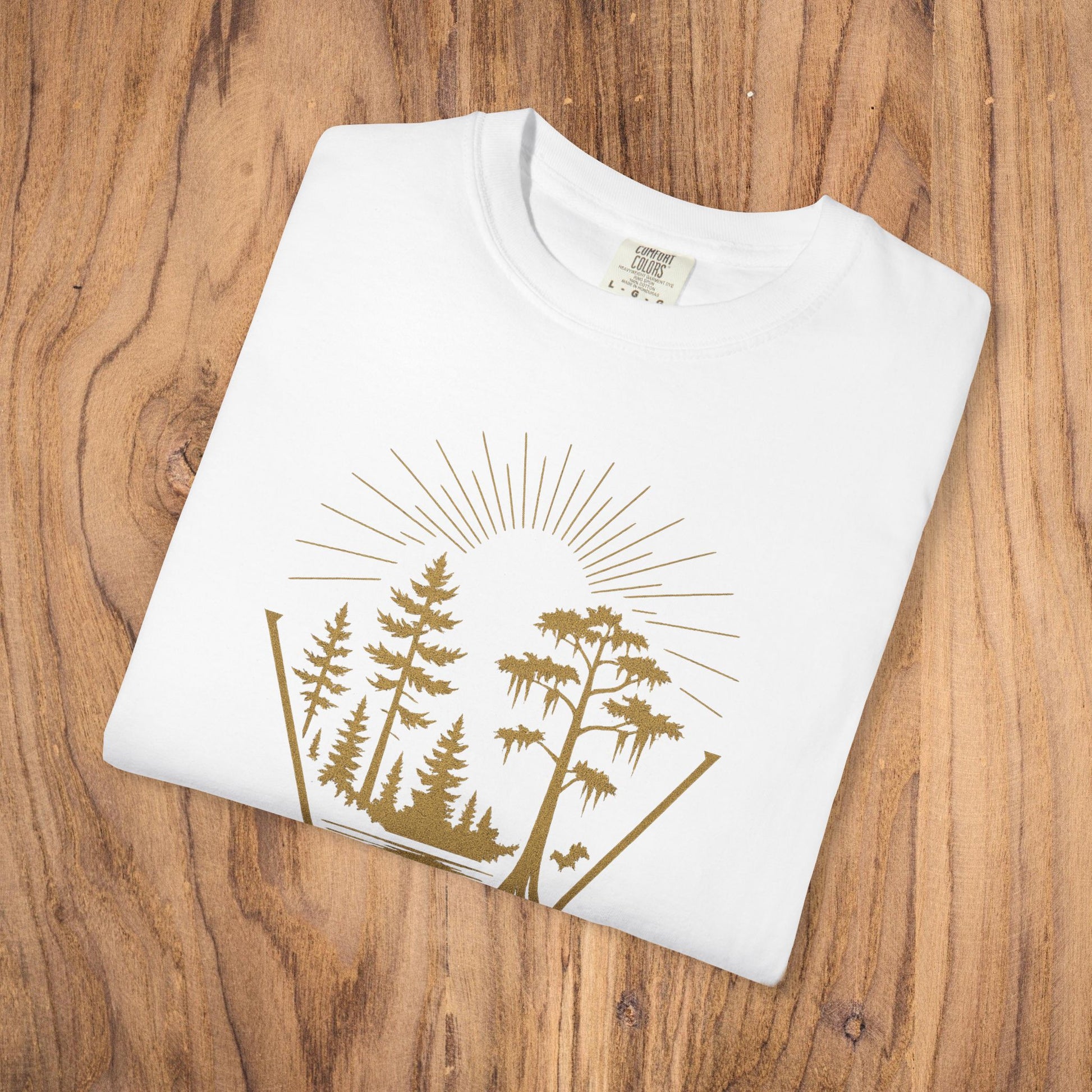 Nature Outdoor Vibes Tee - Soft 100% US Cotton, featuring a fold with a nature-inspired design on a wooden background.