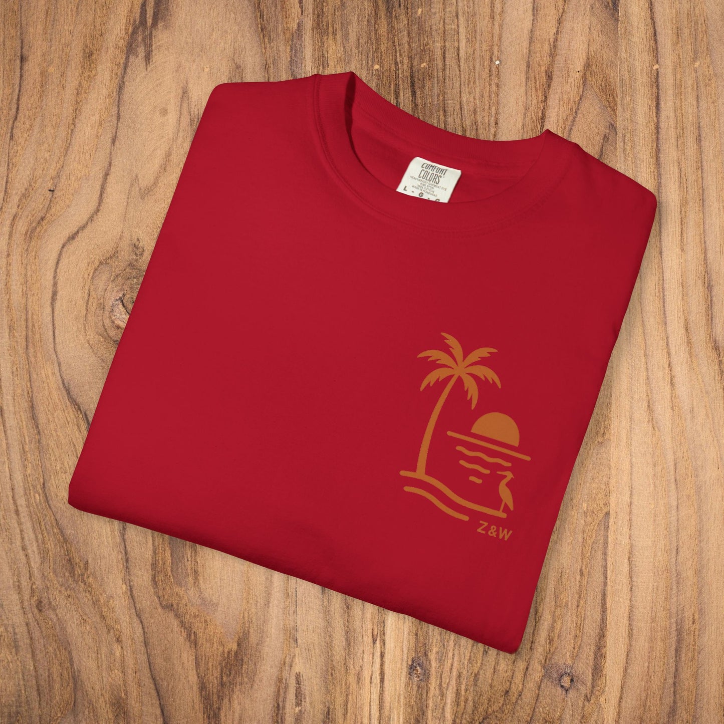 Unisex Sunset Palm Tree T-Shirt presented in red color, featuring a unique palm tree graphic, crafted from high-quality garment-dyed cotton for comfortable wear.