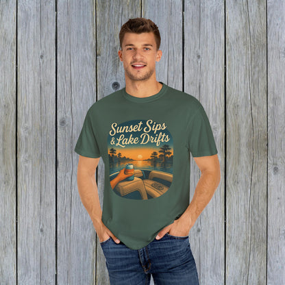 Man wearing army green Lake Drifts T-Shirt with a sunset and lake graphic, emphasizing soft 100% cotton material for comfort.