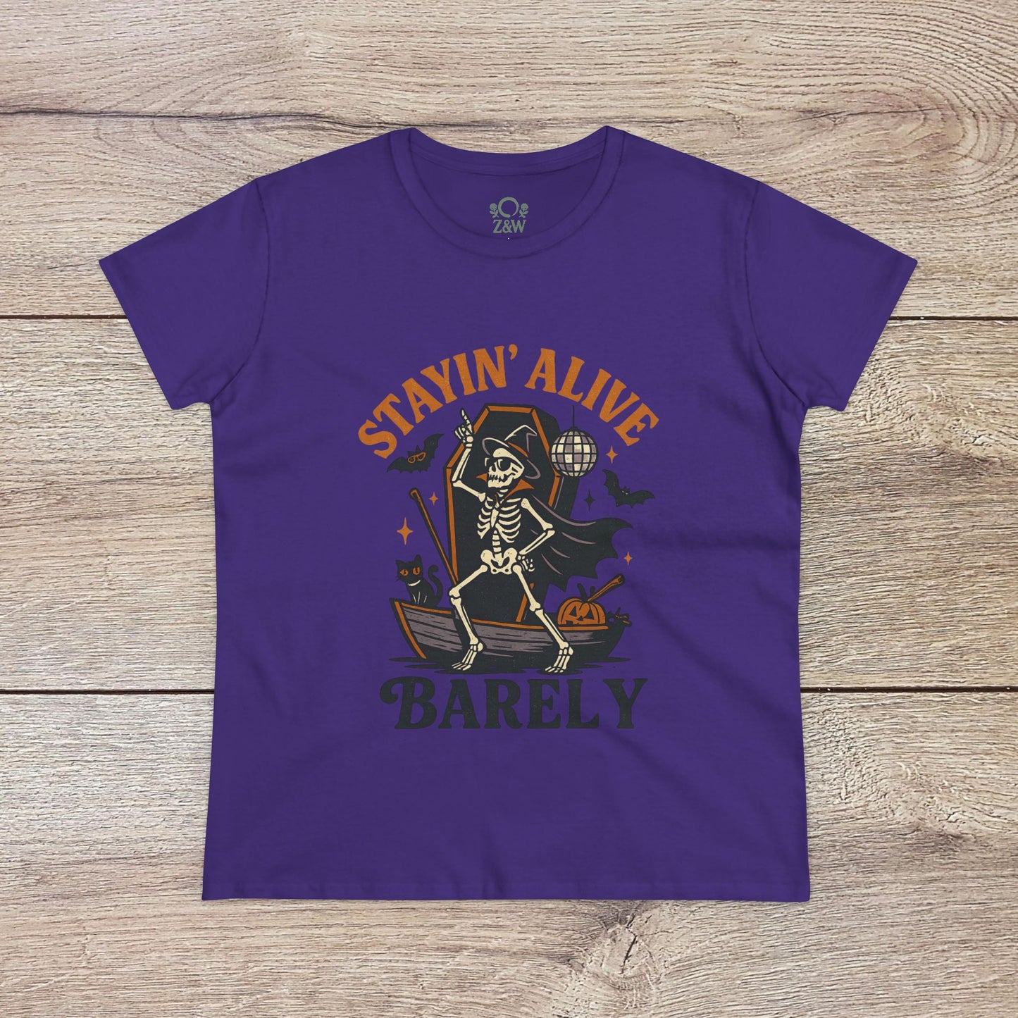 Stayin’ Alive T-Shirt in bold purple showcasing a quirky skeleton design, perfect for Halloween celebrations. Unisex softstyle casual tee that's stylish and unique.