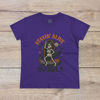 Stayin’ Alive T-Shirt in bold purple showcasing a quirky skeleton design, perfect for Halloween celebrations. Unisex softstyle casual tee that's stylish and unique.