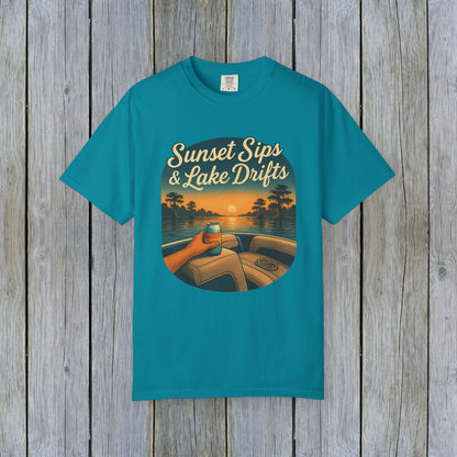 Lake Drifts T-Shirt in vibrant teal showcasing a scenic sunset design with a drink, ideal for warm weather relaxation.