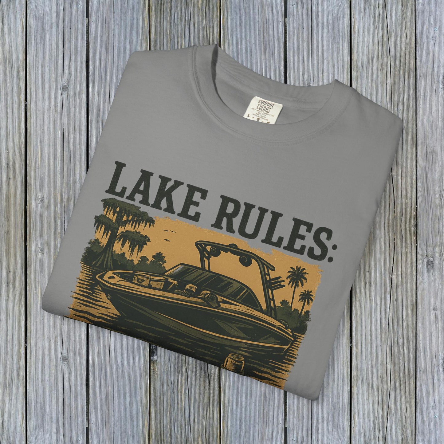 Front view of the Unisex Garment-Dyed Lake Rules Tee, featuring a vibrant graphic with a boat and the text 'Lake Rules' on a gray fabric.