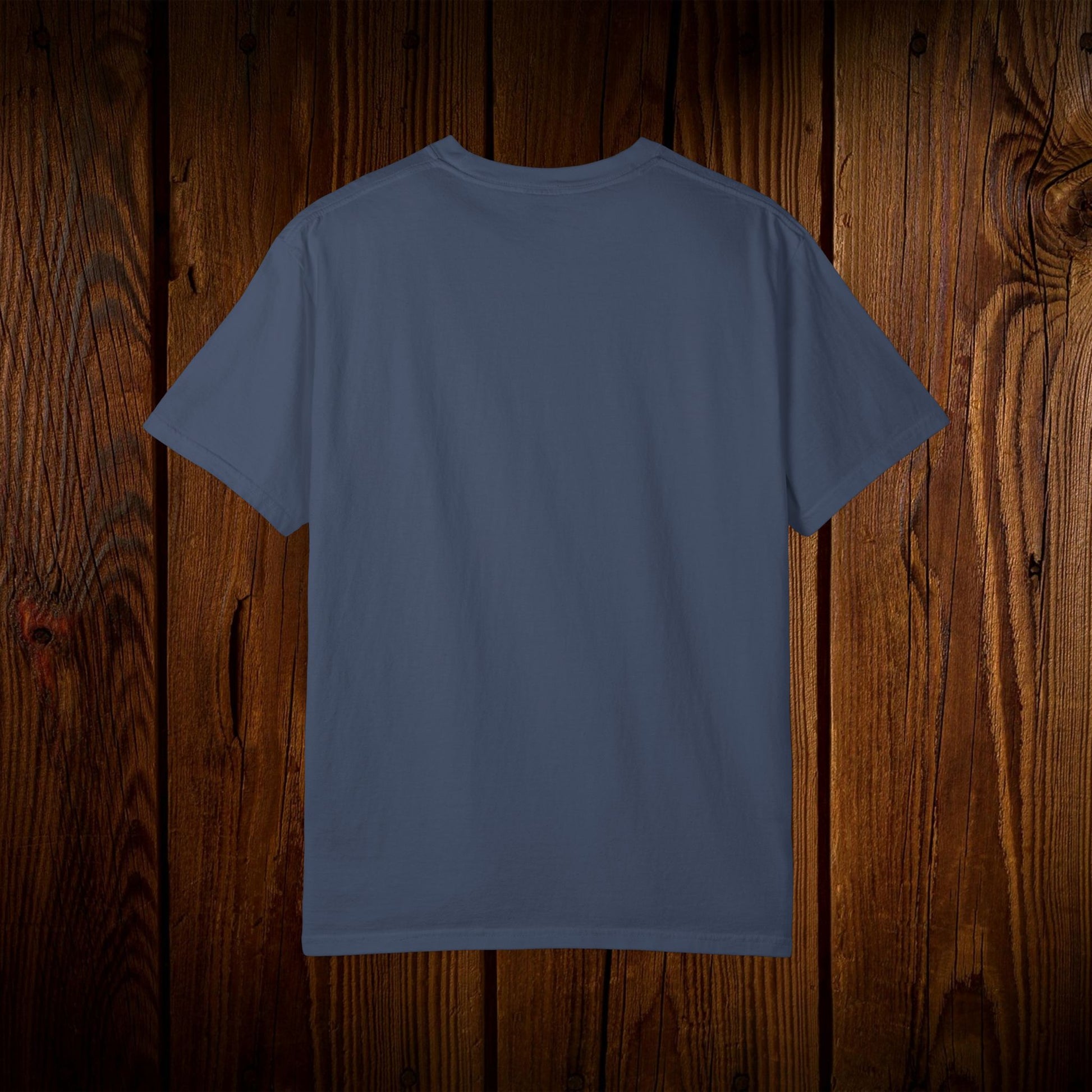 Back view of the Unisex Swamp-Bred Fairway-Fed Tee in a dark blue color, emphasizing its clean design and quality craftsmanship, suitable for casual wear.