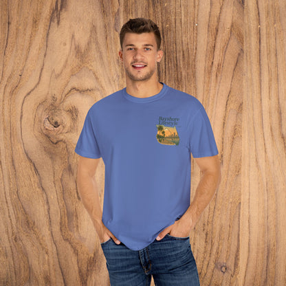 Confident man modeling the Bayshore Lifestyle Tee in blue, emphasizing the relaxed style and 100% cotton material.