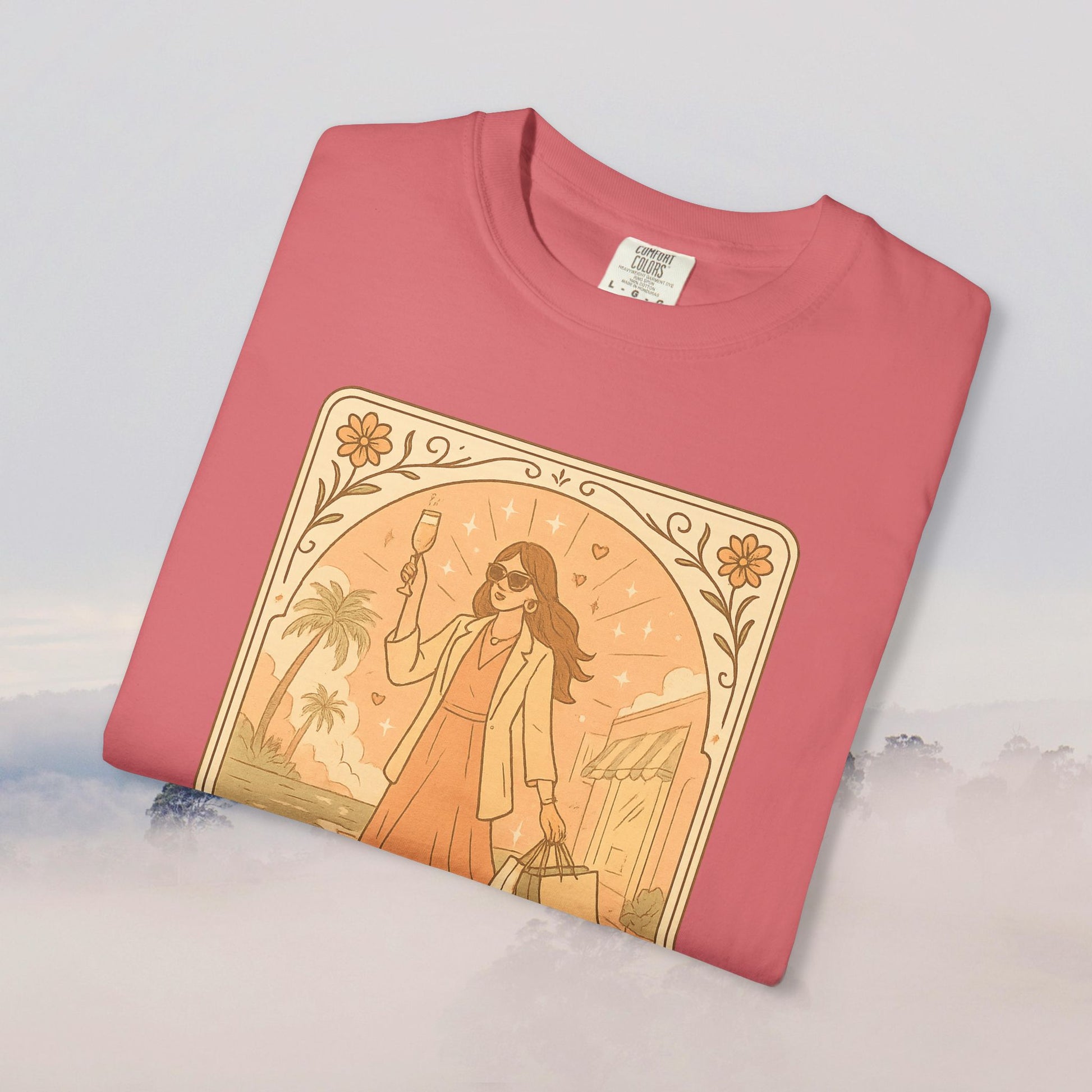 Close-up view of the Brunch Babe Tarot Graphic Tee in coral pink, highlighting the detailed artwork of a woman enjoying brunch.