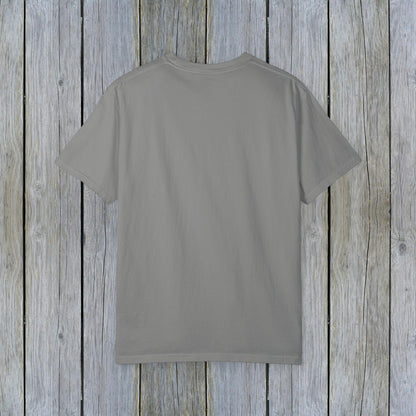 Back view of the Unisex Garment-Dyed Lake Rules Tee, showcasing its classic and relaxed design on a wooden background.