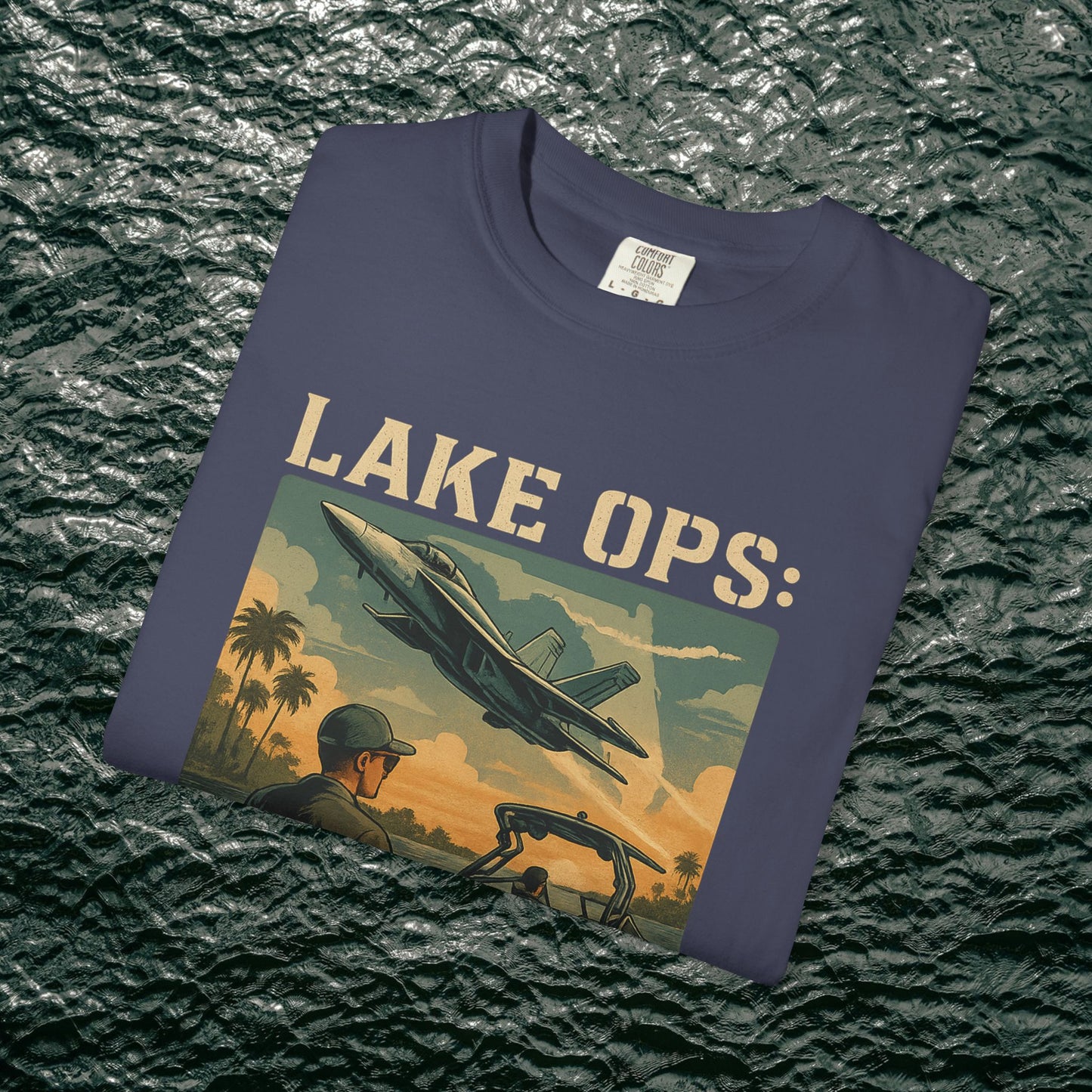 Garment-Dyed Comfort Tee For Adults featuring 'LAKE OPS:' and an aircraft design on a navy background, available in sizes S-4XL.