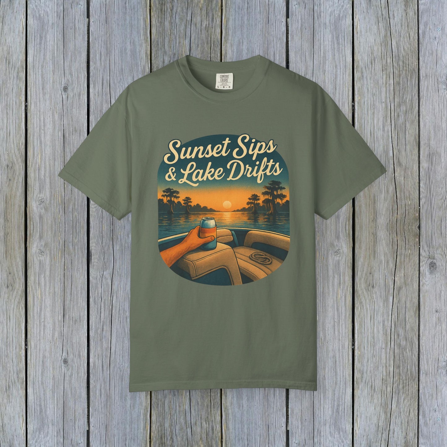 Lake Drifts T-Shirt in olive green with a sunset graphic featuring a hand holding a drink, ideal for lake adventures.