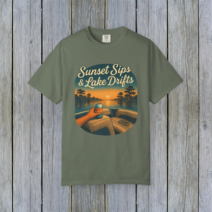 Lake Drifts T-Shirt in olive green with a sunset graphic featuring a hand holding a drink, ideal for lake adventures.