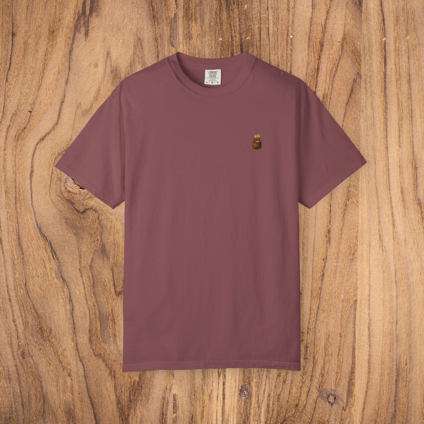 Premium Southern Made T-Shirt featured in a rich burgundy color set against a wooden backdrop, perfect for stylish casual wear.