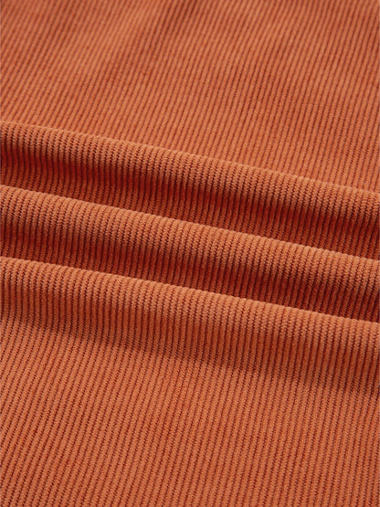 Close-up view of the ribbed texture of the fabric on the Corduroy Western Mini Dress With Embroidered Patch Pocket, showcasing the quality and softness of the 100% polyester material.