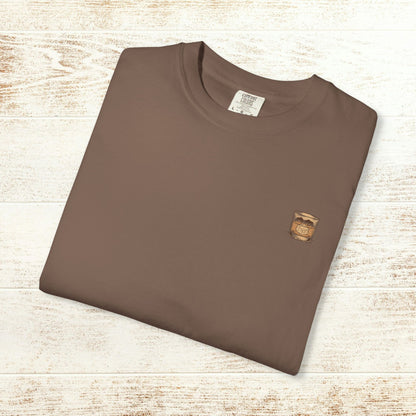 Folded Rodeo On The Rocks Tee in brown color, highlighting the unique garment-dyed style with a soft feel and made from 100% US cotton, available in sizes S-4XL.