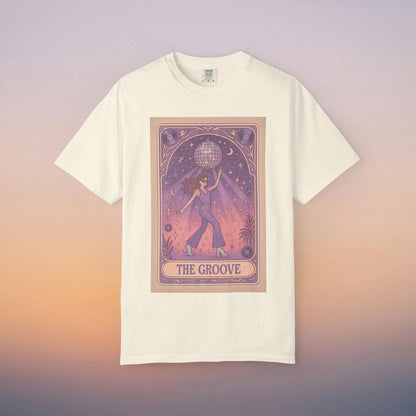 Groove Tarot Graphic Tee in cream color, featuring an artistic design of a figure holding a globe with a starry background. Made from 100% ring-spun cotton for ultimate comfort, available in unisex fit, sizes S-4XL.